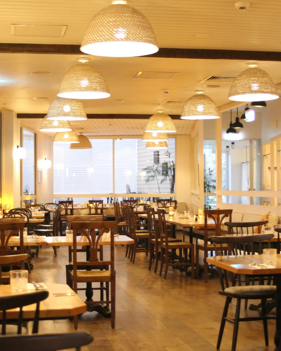 Light-filled dining room with rattan pendant lights